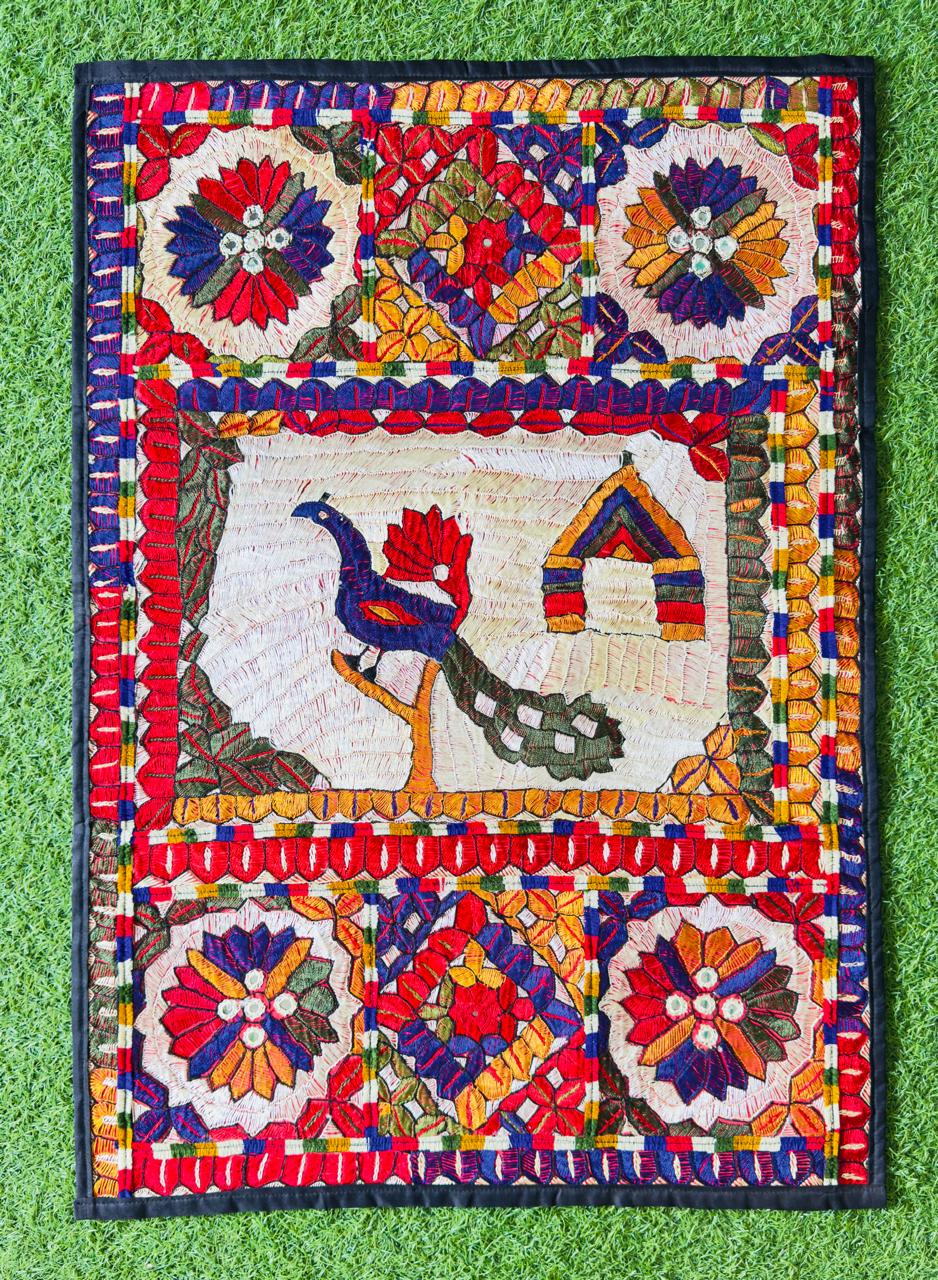 Rectangular embroidered wall hanging with a peacock motif
